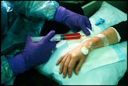 The nurse wears industrial strength protective gloves to ensure against contact with the highly toxic chemicals.   I pick the passport up off the dresser. Turning its royal blue cover, the person I see staring blankly at me on the first page is now dead. Her hair was always perfect, never a strand out of place and definitely no greys. Her eyes look tired, bored even. When she was a little girl they had such a spark. On the family farm she used to climb trees and draw pictures for hours on end. That little girl was a real dreamer. This ID photo, this woman, with her stark and complacent stare, shows a person I could no longer relate to. The woman in the photo is me. My bag lies on the bedroom floor. It’s packed full of the things I will need for my journey around Europe. In two days I will leave for Austria and France but I’m already travelling in my mind. I try to imagine the places I will see, the people I will meet and things I will taste. It feels like a miracle I am still here and able to savour the anticipation. I am the lucky one. Jan didn’t have this second chance. The phone rings interrupting my thoughts. It‘s Sandra phoning to tell me Rose, who was diagnosed with breast cancer a month before me, now has secondary liver cancer. She tells me Rose intends phoning to talk about chemo. The thought scares me. Not because I’m afraid to talk about my experiences, but because I know I will have to be honest about how awful it was. I decide not to wait for her to ring. I make plans to visit her today. I take a huge bunch of pink and white flowers, more to cheer me up than anything. She doesn’t look well, her tummy protrudes and her skin is sallow. She tells me about the treatment she will endure over the time I am away. I hold back tears as I hug her to me, thinking of my own experiences and also my sister’s before me. We talk candidly about treatment, feelings, dreams, family, our children. I want to give her more. I want to give her hope. I grasp for it myself. All I can think to do is promise to light a candle for her in Notre Dame. – Ib