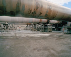 Rust forms on a kiln that was turned off a month prior. As part of a controlled shut down process, the three kilns were stopped in a staggered manner. Positioned near the coastline, salt water effects the machinery, more so when it is not in operation.