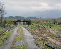 Concrete structures lie directly alongside the Midland Line. The site to the East of the remains of the timber mill, on a hill, is the original forested site for milling. It is now a subdivision, close to the lakeside recreation town of Moana, Lake Brunner.