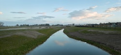 Facing South along water drainage channel across former marshlands.