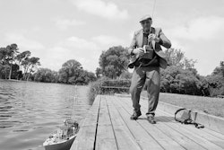 My father, who was a great boatman himself, gave me my first model when I was twelve, the age he’d been when it was given to him. It had been made by a boatbuilder as a sample for a client – beautiful little sailer it was – and it was that that started me making models of my own. Of course we sailed a lot with my father in his different boats, wonderful places around the coast of southern England where I grew up. There’s nothing better really, that feeling that the boat is almost a living thing and you’re out there riding on the swell with nothing in front of you except the horizon. Oh yes, that was a great joy, a feeling of complete freedom when anywhere in the world seemed open to you. It was all I wanted to do really, and when I left school I was offered an apprenticeship with Dixons, who were the major boatbuilders then in Exmouth. They built fishing boats, pleasure boats, the lot. A four-year course which was to cost Dad eighty pounds and no return on the money. Well, that was a tremendous amount of pounds and I don’t really think he had it. Not with wages as they were back then. And so I missed out on it – missed out on my dream. My mother had her sights on me becoming a bank manager, and that’s where I went, into a bank. It was a disaster, a complete mess. Ha, I think I came to the other side of the world to get away from the embarrassment. Came out to a job with the Bank of New Zealand, met my wife, Margaret, and this is where I stayed. One thing I discovered when I got out here was that New Zealanders, without any formal skills or whatever, made their own boats anyway. Well, that got me going and I set about making a number of small boats myself. Later I had ambitions to go on and build a decent-sized yacht – it was actually in the drawing stage – but that’s when the angina caught up with me. Put an end to it right there. Never mind, I’ve still got the models and I get a lot from them. I suppose it’s the full-sized boats that really give you the love of it, but the models let you relive those moments, that joy you had years ago. And that’s the thing about Lake Victoria too. It’s a large lake which brings back memories of those open horizons. I mean, you can stand at one end looking down the lake – your eye goes down that water – and it’s a mighty long way to the other end. It can set you dreaming, that can, no trouble at all.