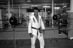 I left home at fifteen because I was the oldest of eight kids and life wasn’t the best. I went into the army – Regular Force Cadets – but only lasted a year. I’m more of an independent thinker. I left, came back into regular life and promptly turned into a little ratbag. Probably the equivalent of a street kid now. After that it was bikes. I loved riding bikes and scaring the hell out of myself. Finally I went through a fence at eighty miles an hour. Wrote the bike off and very nearly myself as well. About then I decided to change the whole direction of my life and do something a bit smart. I’d always wanted to do karate when I was a kid, but my parents couldn’t afford it. Well, for some reason – I still don’t know why – I just decided that was the time to do it. I got into lifting weights, the whole thing. Now, nearly thirty years later, my partner Leonie and I run our own club, the Academy Of Combat, and martial arts has become a major part of my life. I also managed to educate myself along the way. A friend of mine – Janice Brown, a primary school teacher – convinced me I should go back to school. I was thirty-two by then and I said, don’t be silly, I thought I was well past that sort of thing. But she put together the information and finally got me along to Hagley Community College. I started doing maths, physics and chemistry, and then this fantastic teacher called Paul Buist suggested I have a go at biology as well. That got me into biochemistry, and the long and the short of it is that I now have a doctorate in cellular and molecular biology. I’m always looking for information. I think it’s part of who I am. Always striving to learn – doesn’t matter what it is – anything I can get my hands on, I suck it in. It’s the same with the martial arts. I love the combat. I don’t mean thuggery, beating people up, I mean the complexity of manoeuvres involved in a situation between two individuals. It’s a chess match between two people – a physical chess match between people who want to test themselves. It’s not a science; it’s not an art; it’s something in between. A really complex pursuit which is always progressing, always developing. I am not a traditionalist. You come into my gym, you don’t have to stand at the door and bow and all that sort of stuff. I really don’t have much time for that. We have a little acknowledgment when we start fighting, and when we finish everybody shakes hands with each other. We nurture a camaraderie right throughout the gym, but we’re also trying to develop good culture within the individual themselves. You don’t get anything for nothing –you have got to work for it. And the harder you work, the better you get. I’ve had thugs come into the place and expect something from me. We had a couple of guys come in a while back and I asked them straight out, ‘Are you White Power?’ They said, ‘Yeah, but we leave our politics at the door.’ I said, ‘Well, I don’t. Get out.’ I won’t have it. Beating up somebody because of their race is totally foreign to me, and I’m certainly not going to teach them how to do it. The people in my gym are my family. I get a tremendous kick out of seeing all these kids coming through. Watching them develop into strong, motivated human beings. They respect me for who I am and what I do, and I feel the same way about them. That’s how I see them. They really are my family – my kids.