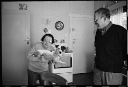 Georgette: We came here for holiday, to stay a couple of months or a year, just to have a look. Everybody ask me about New Zealand. I say look, if you don’t come to New Zealand, you don’t know nothing. You come and you have a look. First of all, the people. In Christchurch all the people we have met have been friendly to us. They’ve been helpful. And that’s the main thing to attract people. So, we stay. Now we are naturalised and we stay for 38 years in Christchurch New Zealand, the most beautiful city in all the world. Beautiful place, good home, good husband, what more do you want? We have nice house – two bedrooms – our room, another room for friends when they come. What more you want? It is on a busy road too, so you can see the people come and go. That’s good. When we meet the man to help us get the house, I say, “Look, the home you’re going to show us, I like to be in a street where there is people. I’m not like some people who want to live in backyard. We want to see people.” When you are pleased with your life everything is good. You have a good husband – I don’t want to say that in front of my husband – but he is excellent. Not only with his wife; with his friends, his workmates, everybody love him. That is important. If you don’t have the right person you feel sorry. I can see with my eyes and I feel sad for some things that I see. Oh well, that is life and you must follow your life as it is. We have come to this country and I am happy for it. All our friends in New Zealand are excellent. I love them, they love me. So, is good. Nick: Actually, when the real estate agent – he stopped across the road – he said “That House?” We said, “Yes, that one.” He said, “You haven’t seen inside it yet!” We said, “It doesn’t matter, that’s the one.” It was bad. Inside was very bad condition but when you have something and you feel it’s your own, you jump at it. I put all my effort in it. My blood, my sweat. I was working 10 or 11 o’clock at night, never mind, I had to do it. There was everything wrong, everything you could think of: cracked ceilings, the windows and the doors were all black varnish – I had to scrape night and day – the roof to do, everything. Where we came from – in Egypt – we used to live in apartments. There was nothing at all to worry about. You maybe paint inside, keep it tidy, no gardens to worry about. That’s it. In New Zealand, to own a house, it’s good, you don’t throw your money away in the rent. But I had to experiment – had to learn a lot of things. Then you feel the satisfaction from what you do. It’s kind of like a flower and you can see it grow. That’s good. Also, last thing, busy road is good road. We like that. It’s what we were used to – people. Some others they are different, they complain about the kids. The movement, the noise, backwards and forwards in their cars, radios and all that – we don’t mind. They don’t have much to do, so, you know, you look out and see them enjoying their life. Has to be good. Yes. Has to be.